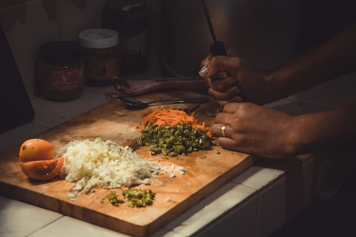 Fresh vegetables being chopped on a kitchen board