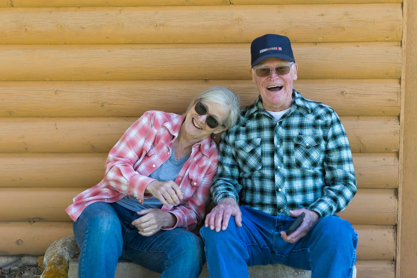 An older couple laughing together outdoors